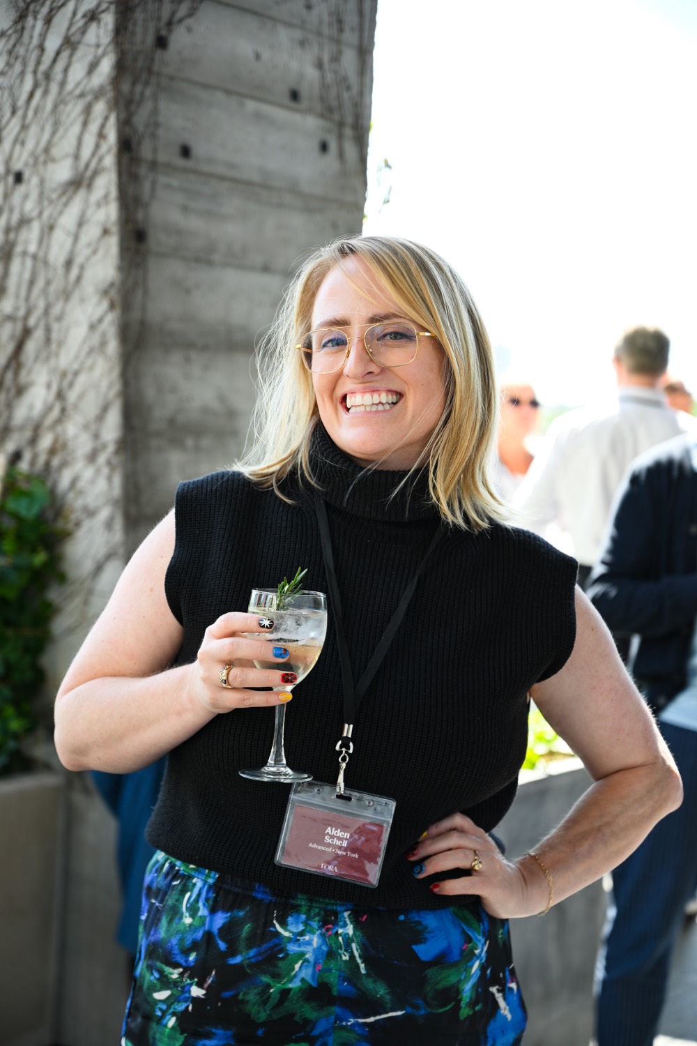 Alden at the Fora LGBTQ+ Travel Summit reception, wearing her advisor badge.